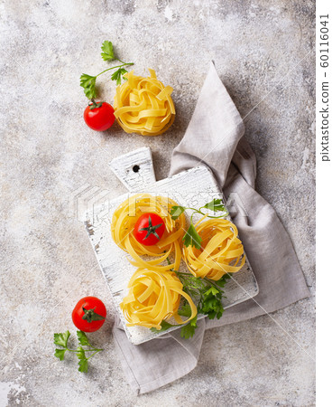 Raw pasta tagliatelle or fettuccine 60116041