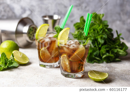 Cuba libre cocktail with mint and lime 60116177