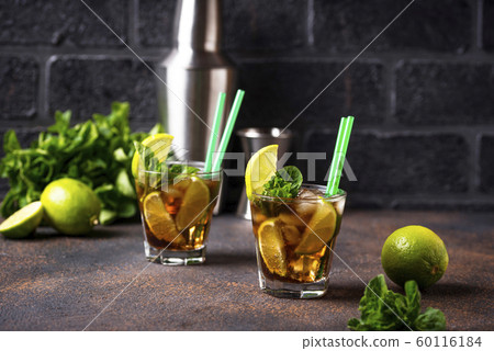 Cuba libre cocktail with mint and lime 60116184