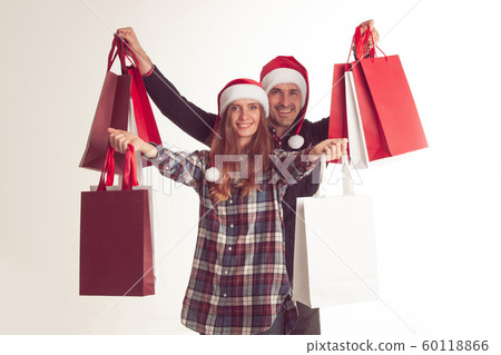 Couple holding christmas shopping bags Couple holding christmas shopping bags 60118866