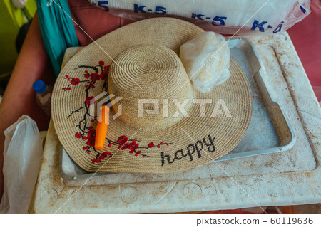 Patterned Straw hat on foam box in summer day Patterned Straw hat on foam box in summer day 60119636