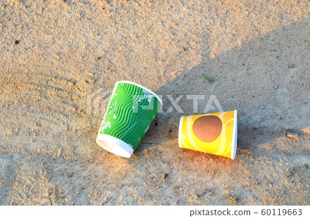 People throw coffee cups to the street. People throw coffee cups to the street. 60119663