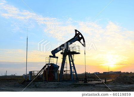 Oil drilling derricks at desert oilfield.  60119859