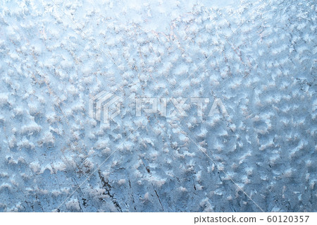 Surface of a winter frozen window is backlit by the sun outside, background, texture 60120357