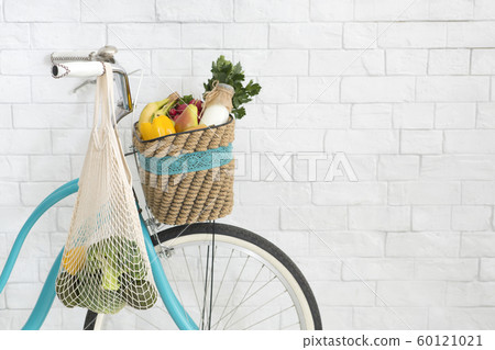 Retro bicycle with fresh products over white bricks wall Retro bicycle with fresh products over white bricks wall 60121021