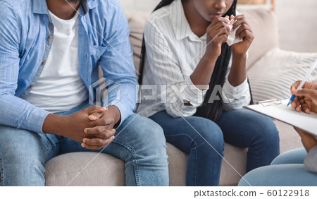 Unrecognizable Black Couple Sitting On Couch At Marital Counselor's Office Unrecognizable Black Couple Sitting On Couch At Marital Counselor's Office 60122918