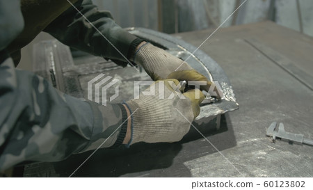 Forge workshop on table. Smithy manual production. Work on the product. Ruler, angle grinder. The blacksmith manufacture of fireplaces, stoves. 60123802