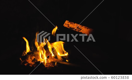 Forge fire in furnace. Blacksmith tempers a steel product in a stove. Smithy forging for hardening and heating iron. Blacksmith stove. Slow Motion. 60123838