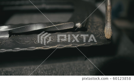 Forge workshop. The product is artificially aged. Gold powder painting of scratches, roughness and scuffs. Ageing. Aging processes. Pattern on iron. 60123858