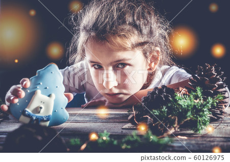 Caucasian sad girl with Christmas gingerbread 60126975