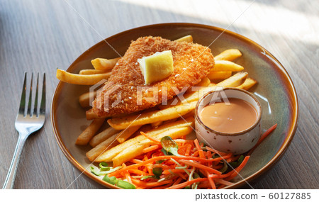 fried fish fellet wiht french fries and veggies on fried fish fellet wiht french fries and veggies on 60127885
