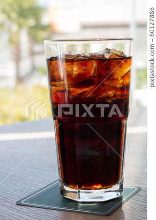 glass of soft drink with summer view 60127886
