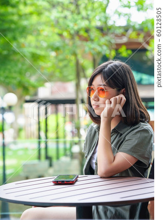 woman sitting in cafe terrace woman sitting in cafe terrace 60128505
