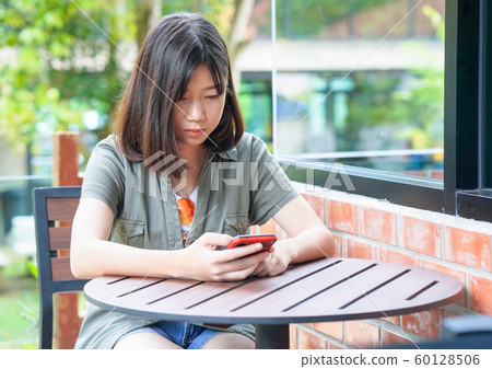 woman sitting in cafe terrace 60128506