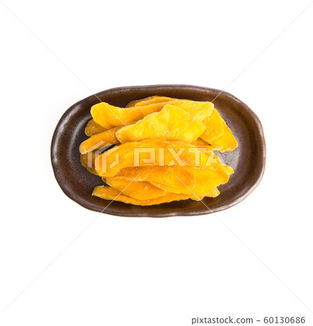 Dried Mango or Dried Mango slices on a background Dried Mango or Dried Mango slices on a background 60130686