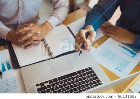 Two businessmen are together analyzing the 60131682