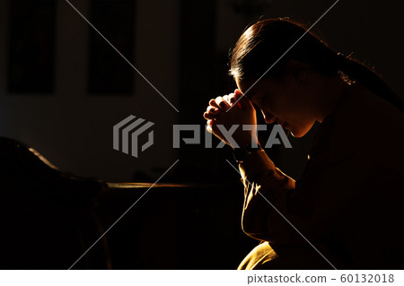 depressed women sitting in the low light church and praying, International Human Rights day concept 60132018
