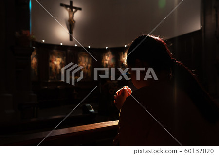 depressed women sitting in the low light church and praying to Jesus on the cross, Human Rights day depressed women sitting in the low light church and praying to Jesus on the cross, Human Rights day 60132020