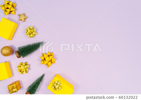 Christmas decoration. Gifts, yellow and golden decorations on purple background. Christmas, winter Christmas decoration. Gifts, yellow and golden decorations on purple background. Christmas, winter 60132022