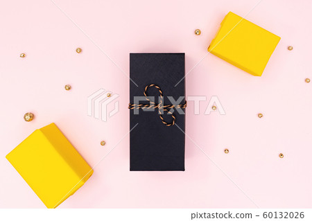 Christmas Gift box, black and yellow present box on pink background. Christmas, winter, new year Christmas Gift box, black and yellow present box on pink background. Christmas, winter, new year 60132026