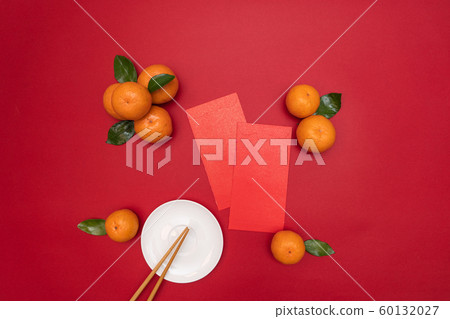 Flat lay Chinese lunar new year traditional food and offering red envelope on table top Flat lay Chinese lunar new year traditional food and offering red envelope on table top 60132027
