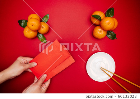 Flat lay Chinese lunar new year traditional food and offering red envelope on table top Flat lay Chinese lunar new year traditional food and offering red envelope on table top 60132028