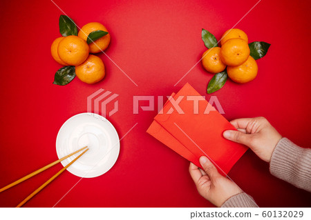 Flat lay Chinese lunar new year traditional food and offering red envelope on table top Flat lay Chinese lunar new year traditional food and offering red envelope on table top 60132029