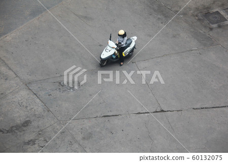 A woman who pauses and checks shopping list in Vietnam, Ho Chi Minh City, street corner A woman who pauses and checks shopping list in Vietnam, Ho Chi Minh City, street corner 60132075