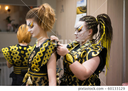 Backstage three actress prepares for the stage 60133129