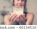 Toned picture of woman hands holding candle 60134510