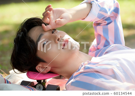 Men lying in the park 60134544