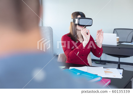 Business professional at work using VR 60135339