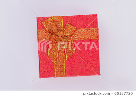 Red gift box with golden floral pattern and bow. Red gift box with golden floral pattern and bow. 60137720