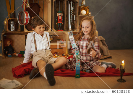Two Kids Playing With Toys Near the Christmas Tree 60138138