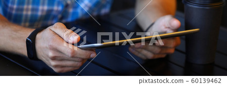 Man with gadget in cafe 60139462