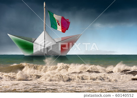 Paper boat with Italian flag in a rough sea and rainy sky 60140552