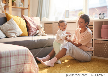 Mother with child in the living room 60142973