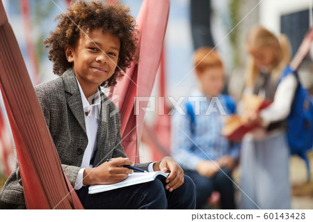 African boy doing homework 60143428
