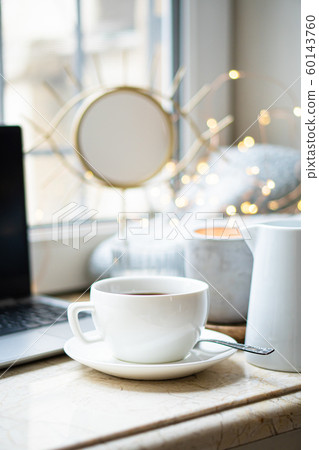 Cozy freelancer's winter work place at home with cup of coffee Cozy freelancer's winter work place at home with cup of coffee 60143760