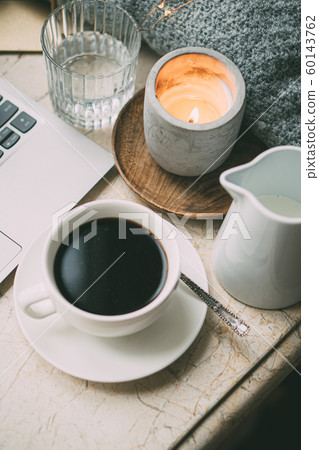 Cozy freelancer's winter work place at home with cup of coffee Cozy freelancer's winter work place at home with cup of coffee 60143762