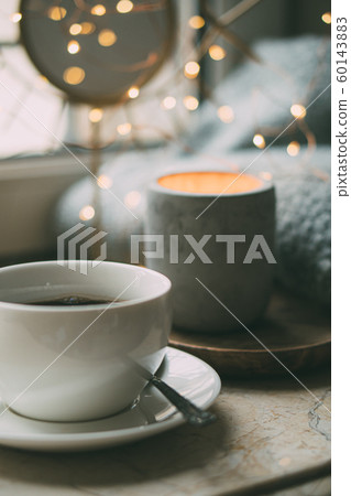 Cozy freelancer's winter work place at home with cup of coffee Cozy freelancer's winter work place at home with cup of coffee 60143883