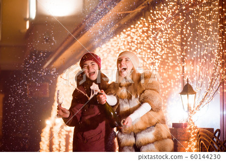 Celebration or party. Friends holding glasses of champagne making a toast Celebration or party. Friends holding glasses of champagne making a toast 60144230