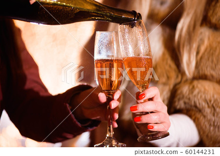 Celebration or party. Friends holding glasses of champagne making a toast Celebration or party. Friends holding glasses of champagne making a toast 60144231