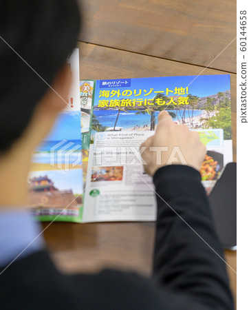 A man planning a trip A man planning a trip 60144658
