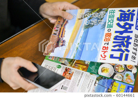 Men planning overseas trip Men planning overseas trip 60144661