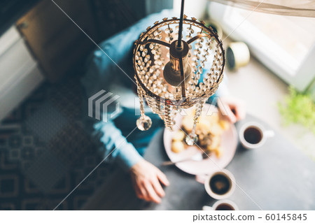 Breakfast at the oval table by the window. Breakfast at the oval table by the window. 60145845