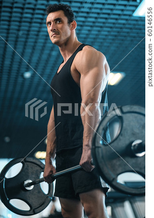 athletic man pumping up muscles and train athletic man pumping up muscles and train 60146556