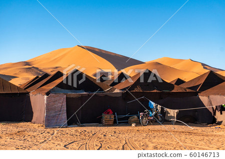 Luxury brown tent camp in Sahara Desert Merzouga, Morocco on a sunny day with sand dunes on background Luxury brown tent camp in Sahara Desert Merzouga, Morocco on a sunny day with sand dunes on background 60146713
