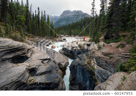 Traveler standing on rock in Mistaya Canyon and 60147955