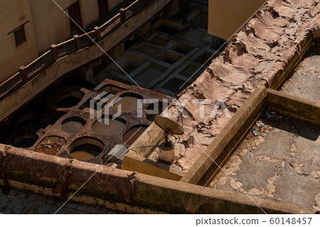 Chouara tannery in old medina in Fes, a traditional and old tannery with workers working making methods of leather in the city Fes, Morocco 60148457